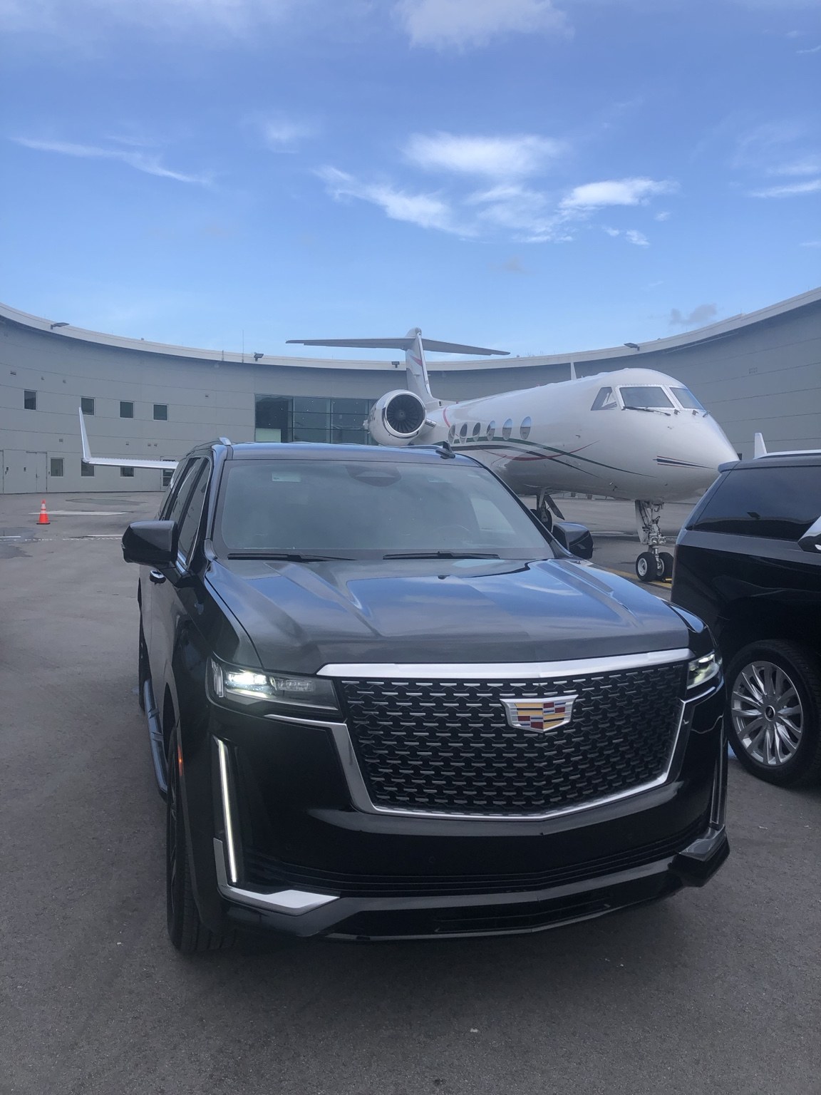 Front view of the Cadillac Escalade parked at a private aviation hangar