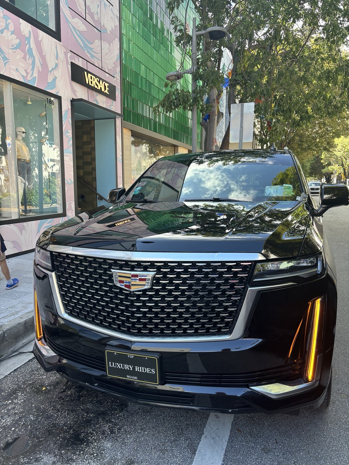 Luxury Rides Miami Cadillac Escalade outside Versace in the Miami Design District